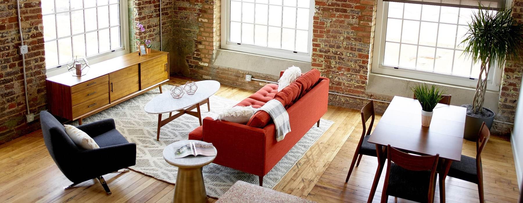a living room with a couch and chairs